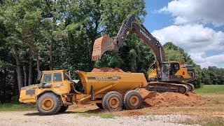 Hauling And Spreading Dirt Around The Shop Preparing For Stone