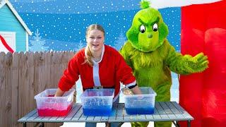 Assistant Helps Santa and the Grinch Make Green Slime in Holiday Town