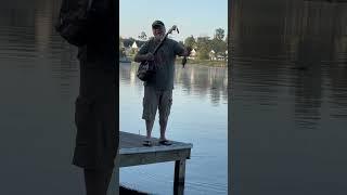 Man Reels in Fish With Banjo