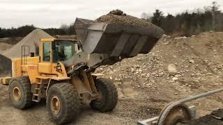 Loading stone slinger truck with 3/4 clear stone gravel with front end loader