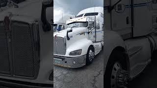 Beautiful white Kenworth rig visor light V shape bumper lights cutouts light blue dark blue stripes