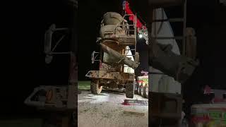 Heavy wrecker Century 1150 rotator lifting a cement mixer