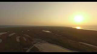 Drone filming the sunrise over a steppe island in the Black Sea | Stock video for editing