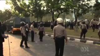 Police and protesters clash in Jakarta