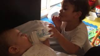 Big brother feeds baby brother