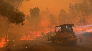 California residents flee massive wildfire sparked by burning car