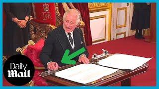 Moment King Charles III furiously motions for aide to move ink pot as he signs proclamation