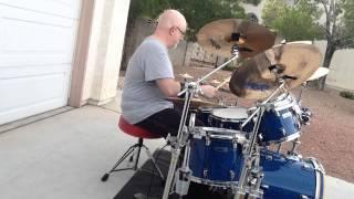 Brian Kell plays drums outdoors