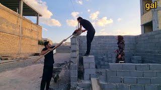 Simple life, high walls: a nomadic man's effort to build a house with the help of his family