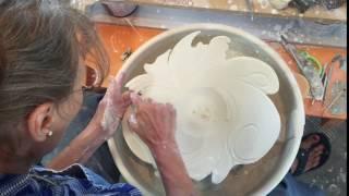 Antoinette Altering and carving a porcelain wheel thrown,  wide rimmed bowl