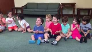 Hysterical and contagious laughing  boy in music class