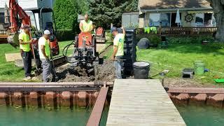 Yard Drainage Contractors Installing a French Drain to Yard Sump Pump System