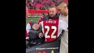 Hakim ziyech gives his ajax's shirt to a fan in the stadium 