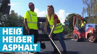 Ein harter Job: Asphalt aufbringen in der Sommerhitze