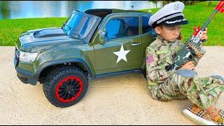 Senya plays with the military car