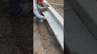 The process of laying granite on the shoulder of the road