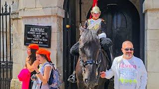 GRINNING TOURIST LETS KING'S GUARD RIDE HIS HORSE - SUMMER hordes arrive at Horse Guards!