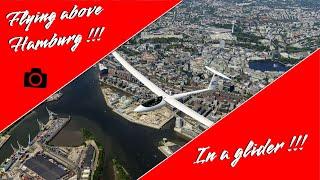 Glider air-to-air shooting above the roofs of hamburg's megacity.