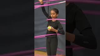 Girl solves a rotating puzzle cube while hula hooping with 5 hoops #shorts