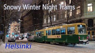Trams in Helsinki on a snowy winter evening.