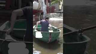 Man 'crosses road' in boat after Nova Kakhovka dam destroyed in Ukraine