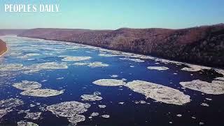 Clusters of drifting ice sparkle like diamonds on the Heilongjiang River