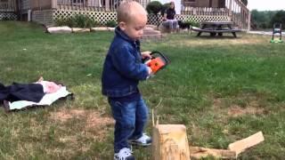 Parker and his toy Stihl chainsaw