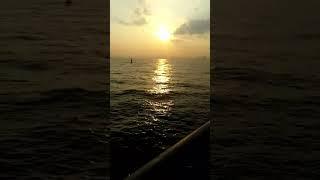 Sun rising at sea