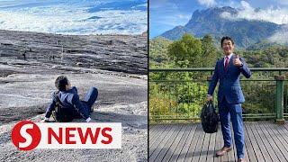 Japanese businessman hikes Mt Kinabalu in full suit