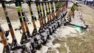 Snow covered rental push scooters on ground in city