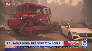 Palisades Fire: Bulldozer moves cars blocking road