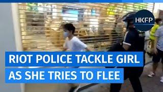 Hong Kong riot police tackle young girl in Mong Kok as she tries to flee