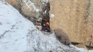 Extreme winter camping in a snowstorm trying to survive a cold night in the wild mountains