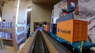 Modelleisenbahn durch Bücherregal und Kleiderschrank