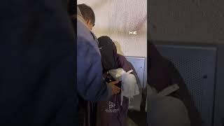 Palestinian mother cries while holding the body of her child