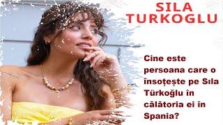 Who is the person accompanying Sıla Türkoğlu on her trip to Spain?