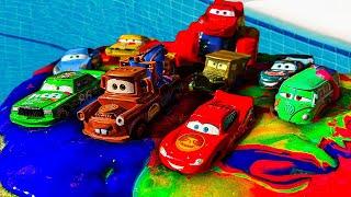 Disney Pixar Cars fall into the water: Lightning McQueen, Chick Hicks, Jackson Storm, Mater