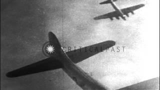 A burning American B-17 aircraft falls through clouds in Germany. HD Stock Footage