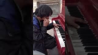 Street piano playing by a homeless, dancer in the dark!