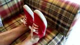 Red Keds on the plaid couch