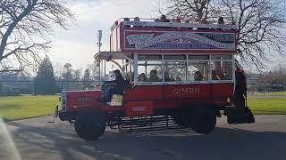 1920's Open top bus drive buy and on board.