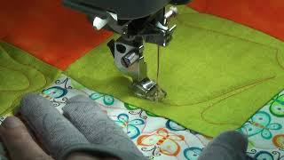 Quilting a flower in a four-patch on a domestic machine