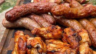 Chicken wings and sausages on grills el barril