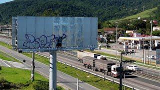 Daytime Graffiti on Billboard with Drone Footage