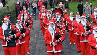 Christmas celebration in Scotland Hundreds of Santas run along to Bagpipe Music|