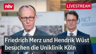 LIVE: Statements von Hendrik Wüst und Friedrich Merz nach Besuch der Uniklinik Köln