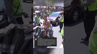 Police stop a foreign scooter rider without a helmet in Ubud Bali