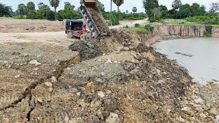 Update Process Filling Stone Into Deeply Large Pond Use Bulldozer Push Stone, Truck Unloading Stone