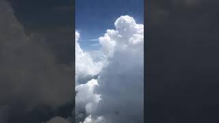 Big puffy white clouds in the sky. Flight from Kansas City to Houston. Flying through clouds.