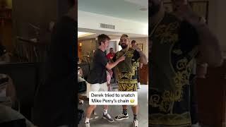 Derek tried to snatch Mike Perry's chain 